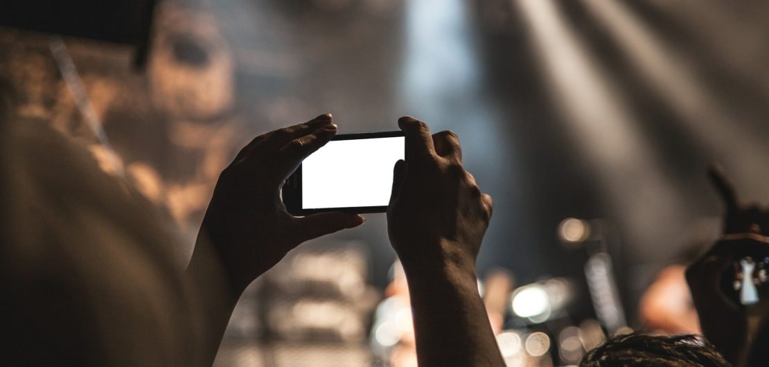 mobile phone filming at a gig
